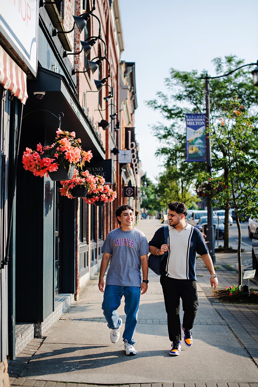 Students walking on sidewalk downtown