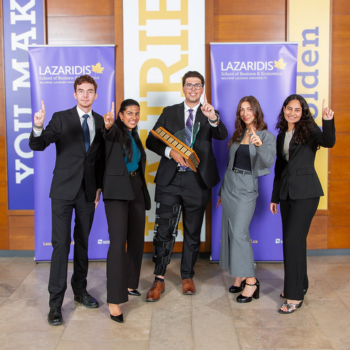 Team 64 posing with the ICE trophy in front of Lazaridis School banners