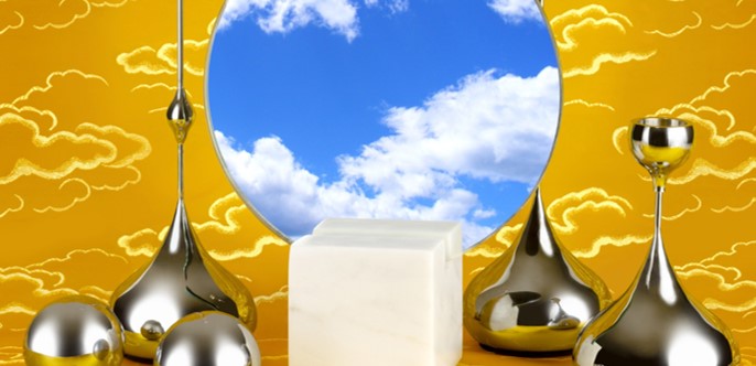 In the centre is a circular mirror with a reflection of a blue sky and cumulus clouds. To the left and right of the mirror are smooth metal spheres and abstract metal tear-shaped structures that merge into long vertical stems that become bowl-like structures. In front of the mirror and between the metal structures is a small even-textured marble cube. All the elements are on a flat, yellow cloud patterned surface and background.