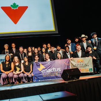 A group of people on stage under a Canadian Tire sign.