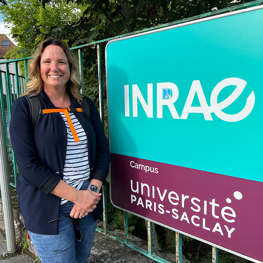 Stephanie DeWitte-Orr in front of an INRAE sign