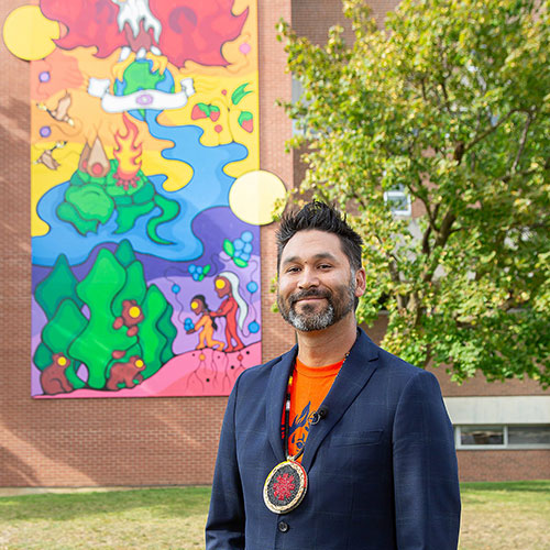 Mike Cywink poses with his mural