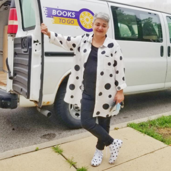 Woman standing in front of white delivery van.