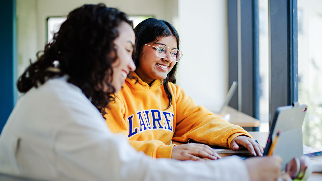 Students work at computer together